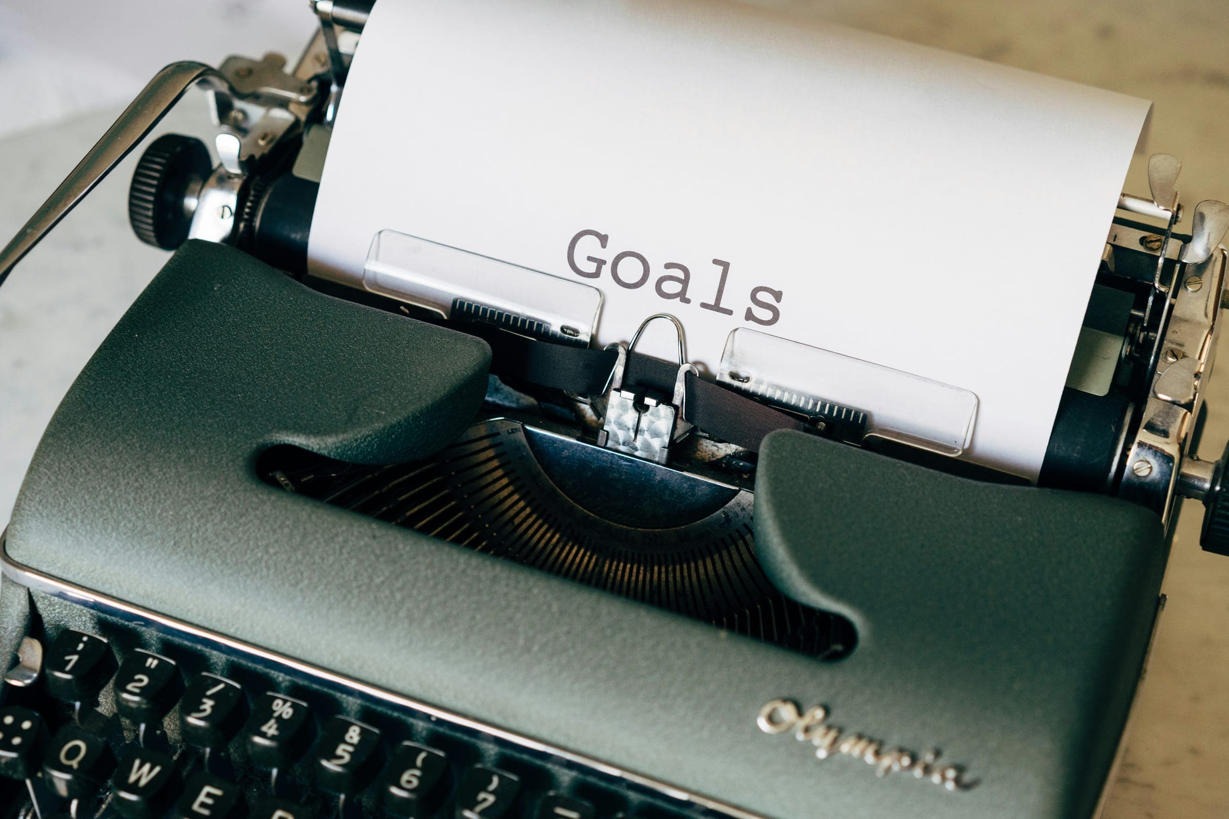 A vintage typewriter with the word Goals typed on the paper